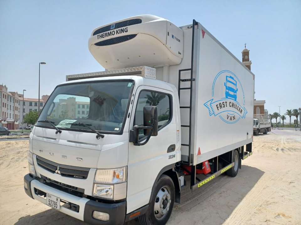 White box-body refrigerated truck with roof-mounted cooling unit operating in Dubai and Abu Dhabi